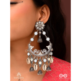 CHANDRAMAYURA- MOON-PEACOCK EARRINGS- OXIDIZED CHAANDBAALI EARRINGS, ADORNED WITH MIRRORS, GHUNGHROOS, COWRIE SHELLS, AND DANGLING JHUMKA